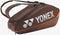 The Yonex 92426EX 6 Racket Pro Tennis Bag in Espresso Brown features two carrying straps, prominent Yonex branding in large white letters on the side, and orange accents, making it the ideal choice for organizing and transporting all your tennis gear to the court.
