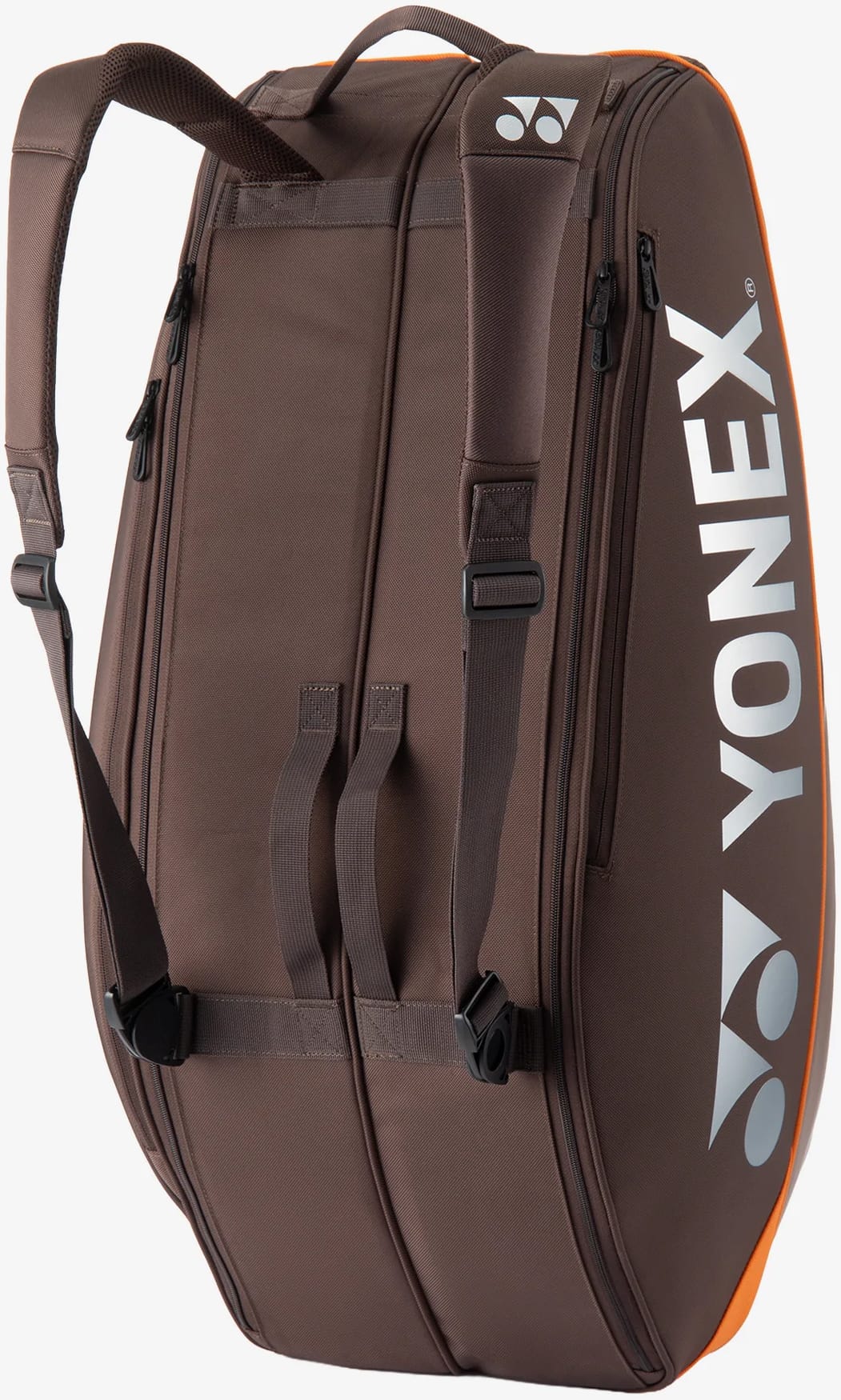 The Yonex 92426EX 6 Racket Pro Tennis Bag in Espresso Brown features shoulder straps, a side handle, and a prominent white Yonex logo. It includes orange accents, visible zippers, and is designed as a spacious bag for carrying up to six rackets or other sports equipment.