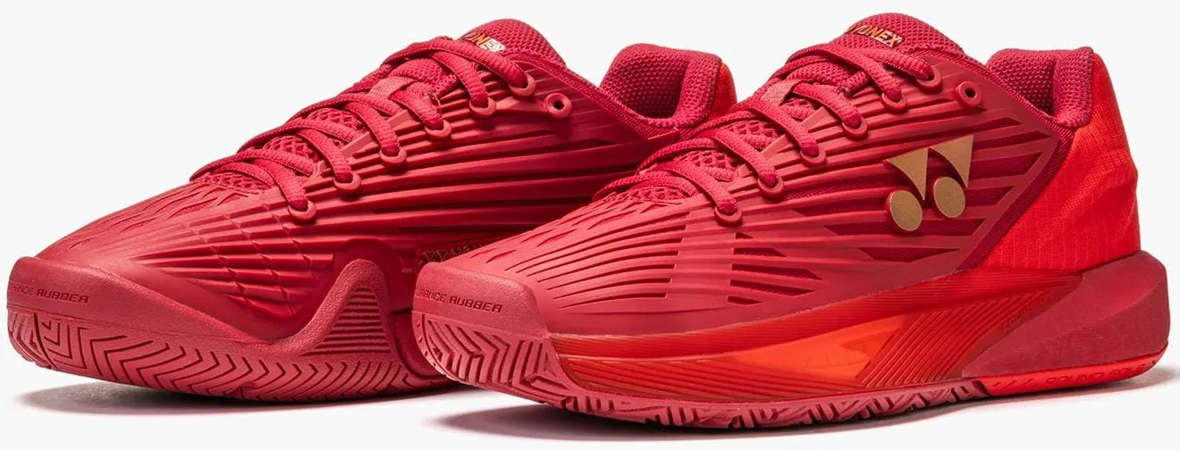 Yonex Power Cushion Eclipsion 5 Womens Tennis Shoes in Ruby Red feature textured uppers, gold side logos, detailed patterns, and a sturdy non-slip sole.