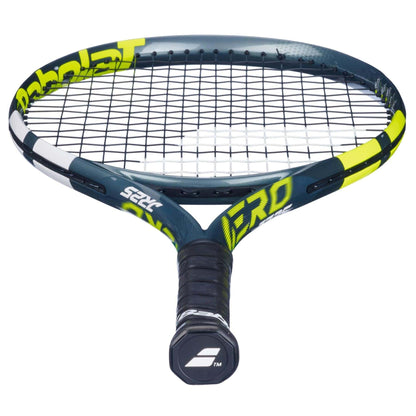 A close-up of the Babolat Aero Junior 25 Tennis Racket 2026 by Babolat shows its black and yellow graphite composite frame, tightly strung strings, and a wrapped black handle with the Babolat logo on the butt cap.