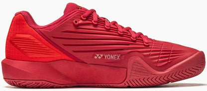 The Yonex Power Cushion Eclipsion 5 Men’s Tennis Shoes in Ruby Red feature a textured sole, ribbed design, and lace-up closure. Advanced tennis shoe technology is showcased in this side view on a white background.