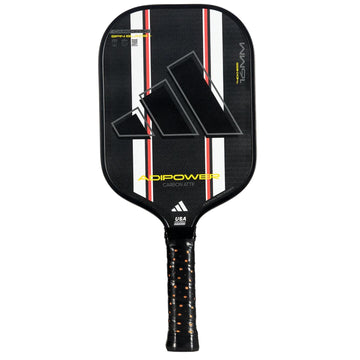 The adidas ADIDAS Adipower Carbon ATTK 3.3 Pickleball Paddle features 3K Carbon, a textured black surface with red, white, and gray diagonal stripes, plus a black cushioned handle with orange accents.