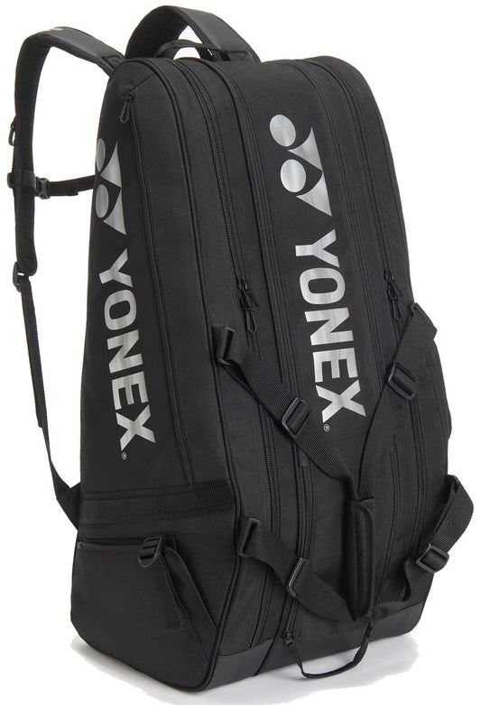 The Yonex BA72629EX Gearlogic 9 Racket Tennis Bag in black features multiple zippered compartments, adjustable shoulder straps, and the white Yonex logo—perfect for serious players seeking ample space for up to 9 rackets.