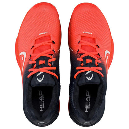 The HEAD Revolt Pro 4.0 Men's Tennis Shoes in bright orange and black showcase a sleek design with laces, infused with performance technologies. The brand "HEAD" is prominently displayed on the tongue, complemented by a small white logo on the sides, visible from an aerial perspective.