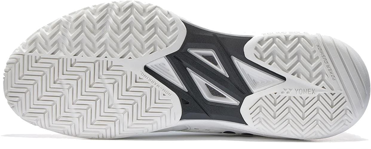 Close-up of the Yonex Power Cushion Sonicage Wide Unisex Tennis Shoes - White, showing a black and white zigzag sole with “Power Cushion” and “Round Sole” visible—ideal for players needing durable grip on the court.