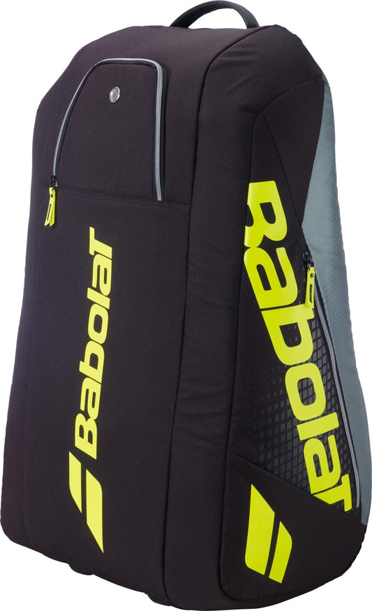 The Babolat RH12 Pure Aero 12 Racket Tennis Bag in grey and yellow is designed to carry tennis gear and rackets, featuring zippered compartments and bold Babolat branding.