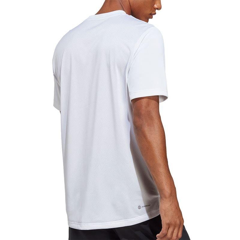A person is depicted from behind wearing the ADIDAS Men's Club Tennis T-Shirt in white, showcasing its short sleeves and relaxed fit. Crafted from lightweight, breathable AEROREADY fabric for optimal comfort, this look is perfectly paired with dark shorts for an effortless sporty appearance.