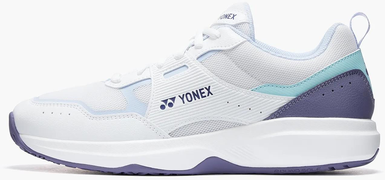 The Yonex Pro-Move Classic Mens Tennis Shoes—White/Sax—feature light blue accents, a purple heel and sole, mesh upper, Yonex logo, and Power Cushion technology for comfort and support on the court.