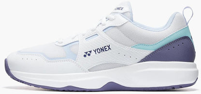 The Yonex Pro-Move Classic Mens Tennis Shoes—White/Sax—feature light blue accents, a purple heel and sole, mesh upper, Yonex logo, and Power Cushion technology for comfort and support on the court.