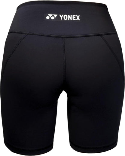 Yonex YTS2024 Womens Core Tennis Shorts in black, shown from the back, feature moisture-wicking fabric, flat seams, and a white Yonex logo on the waistband—ideal for comfort and performance on the court.