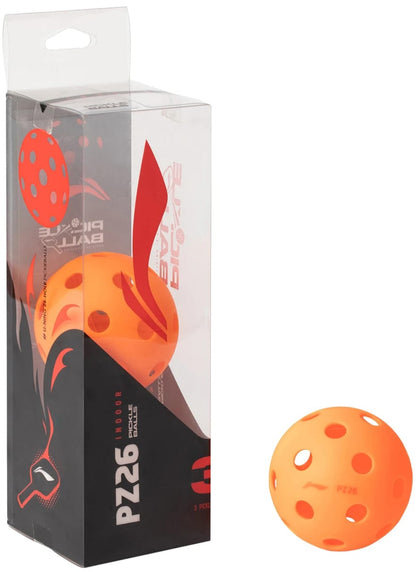 A box of Li-Ning PZ26 Indoor Training Pickleball Balls (3 Ball) - Orange is displayed next to a single high visibility orange 26-hole pickleball ball with multiple holes. The packaging, branded with the Li-Ning logo, is primarily black with red and white accents and features images of the balls.