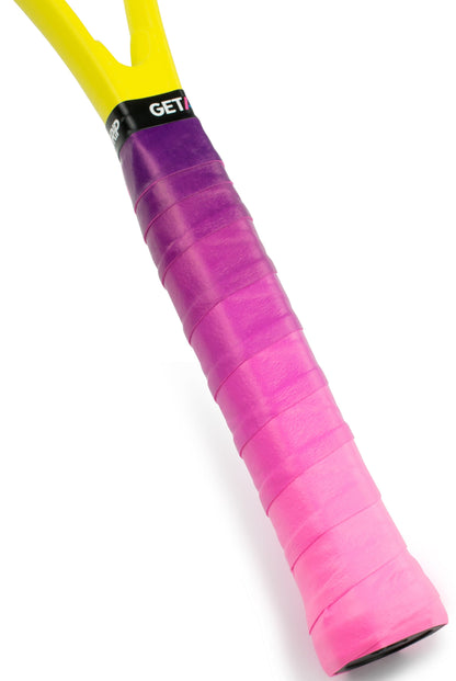 Close-up of a Get A Grip Tennis Overgrip - Cascade, featuring a stylish purple-to-pink gradient wrap on the handle and a hint of yellow racket frame—a unique gift for players who love Get A Grip brand flair on the court.