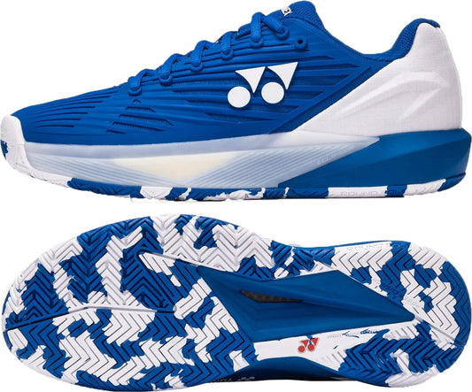 The Yonex Power Cushion Eclipsion 5 Mens Tennis Shoes in blue and white, shown from the side and bottom, feature a blue and white zigzag sole pattern and Yonex’s geometric logo with two circles and a triangle on the side.