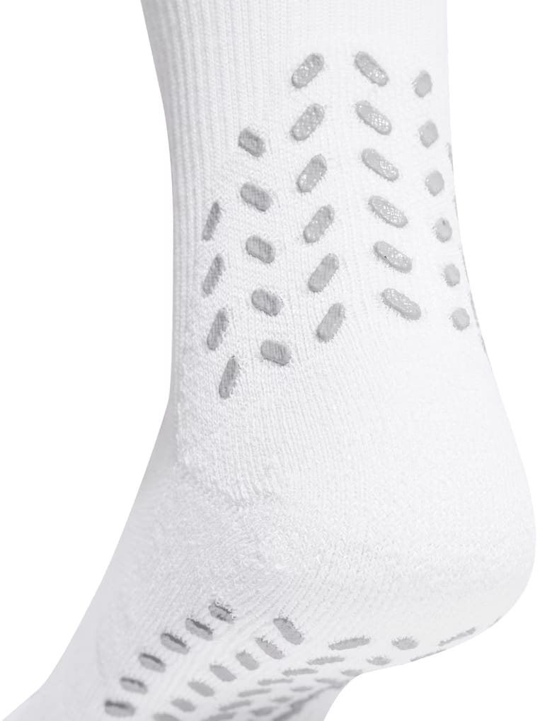 Close-up of the heel of the adidas Performance Cushioned Crew Grip Sports Socks in white, featuring gray rubberized grip dots for enhanced traction, slip prevention, and superior moisture management by adidas.