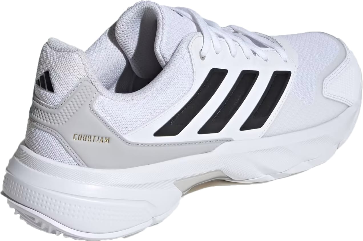 The adidas CourtJam Control 3 Men's Tennis Shoes in Cloud White/Core Black/Grey feature black stripes, grey accents, "COURT JAM" gold lettering at the heel, a textured sole for stability, and a mesh upper for breathability.