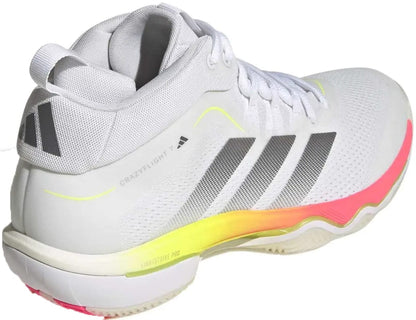 The adidas Crazyflight 7 Men’s Indoor Tennis Shoes in Cloud White/Iron Metallic feature gray stripes, a yellow-pink gradient sole, "CRAZYFLIGHT" text on the side, responsive cushioning, and a textured sole for top indoor performance.