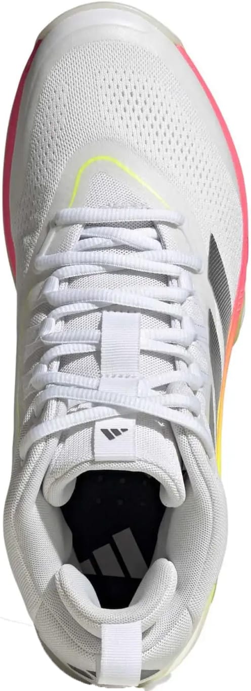The adidas Crazyflight 7 Men’s Indoor Tennis Shoes in Cloud White/Iron Metallic feature white mesh, white laces, a black logo, BOOST midsole, and a gradient sole fading from yellow to orange to pink for responsive cushioning.