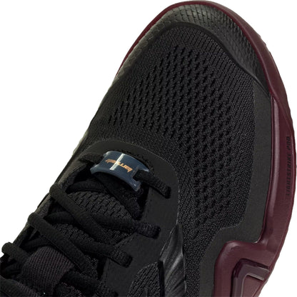 A close-up of the adidas Barricade 14 Men’s Tennis Shoes in Core Black with Maroon accents and mesh detailing, showcasing the laces, toe box, and part of the sole—ideal for baseline players seeking performance-focused footwear.