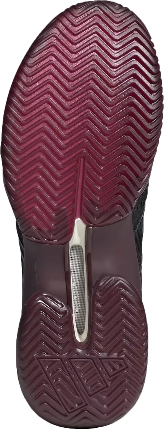 The image features the outsole of the adidas Barricade 14 Men’s Tennis Shoes in Core Black, Core Black, and Maroon, highlighting a black and maroon herringbone tread for enhanced traction and an exposed support structure—perfect for baseline players who prioritize stability on the court.