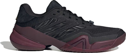 The adidas Barricade 14 Men’s Tennis Shoes in Core Black, Core Black, and Maroon feature a mesh upper, textured side stripes, and a chunky sculpted sole. Designed with a low profile and lace-up closure, these sneakers provide optimal support and stability for baseline players.