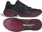 The adidas Barricade 14 Men’s Tennis Shoes in Core Black, Core Black, and Maroon are displayed from a side and sole perspective, emphasizing their textured grip and sleek design features—perfect for baseline players.