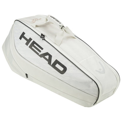 A tennis bag in off white, with "HEAD" prominently displayed on the side, closely resembles the HEAD Pro X Tennis Racket Bag - M - YUBK. It includes various compartments and a carrying handle, ideal for transporting your SPEED racquet series and other tennis gear.