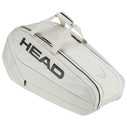 The HEAD Pro X Tennis Racket Bag - M - YUBK is an off-white bag featuring prominent black "HEAD" lettering on the side, drawing inspiration from the SPEED racquet series. It includes two parallel zippers on top and sturdy carrying handles, making it ideal for fans of Novak Djokovic.