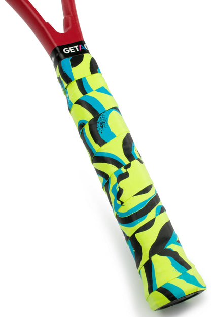 Close-up of a tennis racquet handle with the Get a Grip Tennis Overgrip - The Flow by Get A Grip, featuring vibrant yellow, blue, and black patterns. Red racquet frame near the handle—makes a stylish tennis gift.