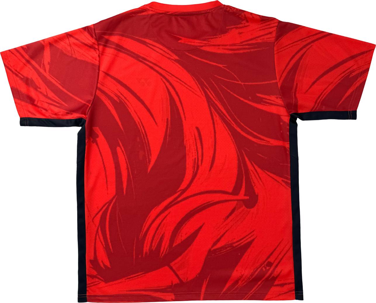 A back view of the Yonex YTM14 Men’s Tennis T-Shirt in Coral, a lightweight short-sleeve polyester top featuring an abstract red and dark red pattern with black side panels. No logos or text are visible.