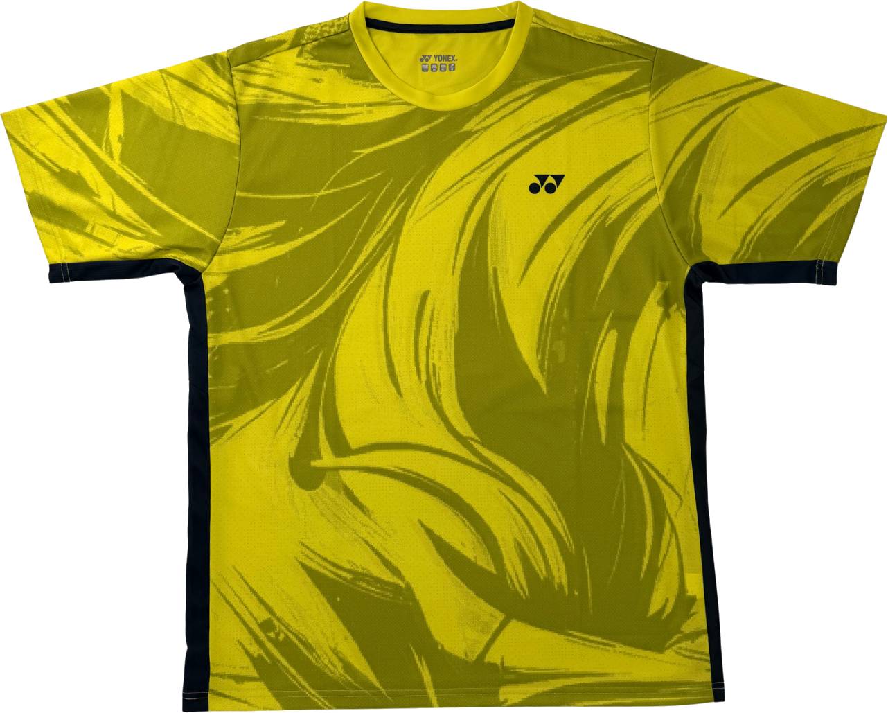 The Yonex YTM14 Mens Tennis T-Shirt in Lime features bold, abstract dark yellow brushstroke patterns and black side panels. Crafted from performance polyester with an athletic fit, this Yonex t-shirt sports a small logo on the left chest, making it an ideal choice for tennis players seeking both style and functionality.