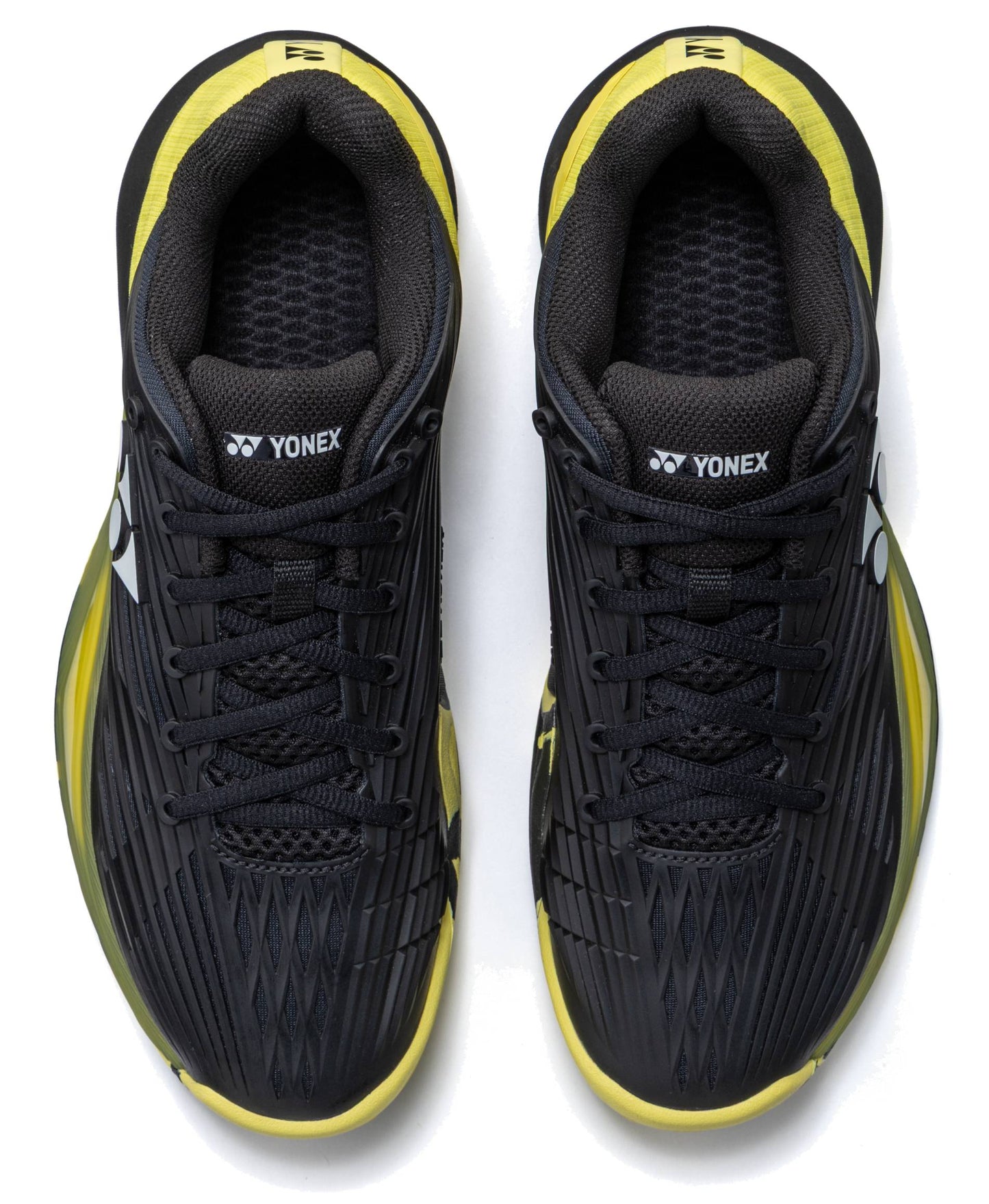 A pair of Yonex Power Cushion Eclipsion 5 Men’s Tennis Shoes in black and yellow, viewed from above. These shoes feature black laces, yellow accents, the Yonex logo on the tongues and sides, and incorporate Yonex’s Power Cushion technology for superior stability on the court.