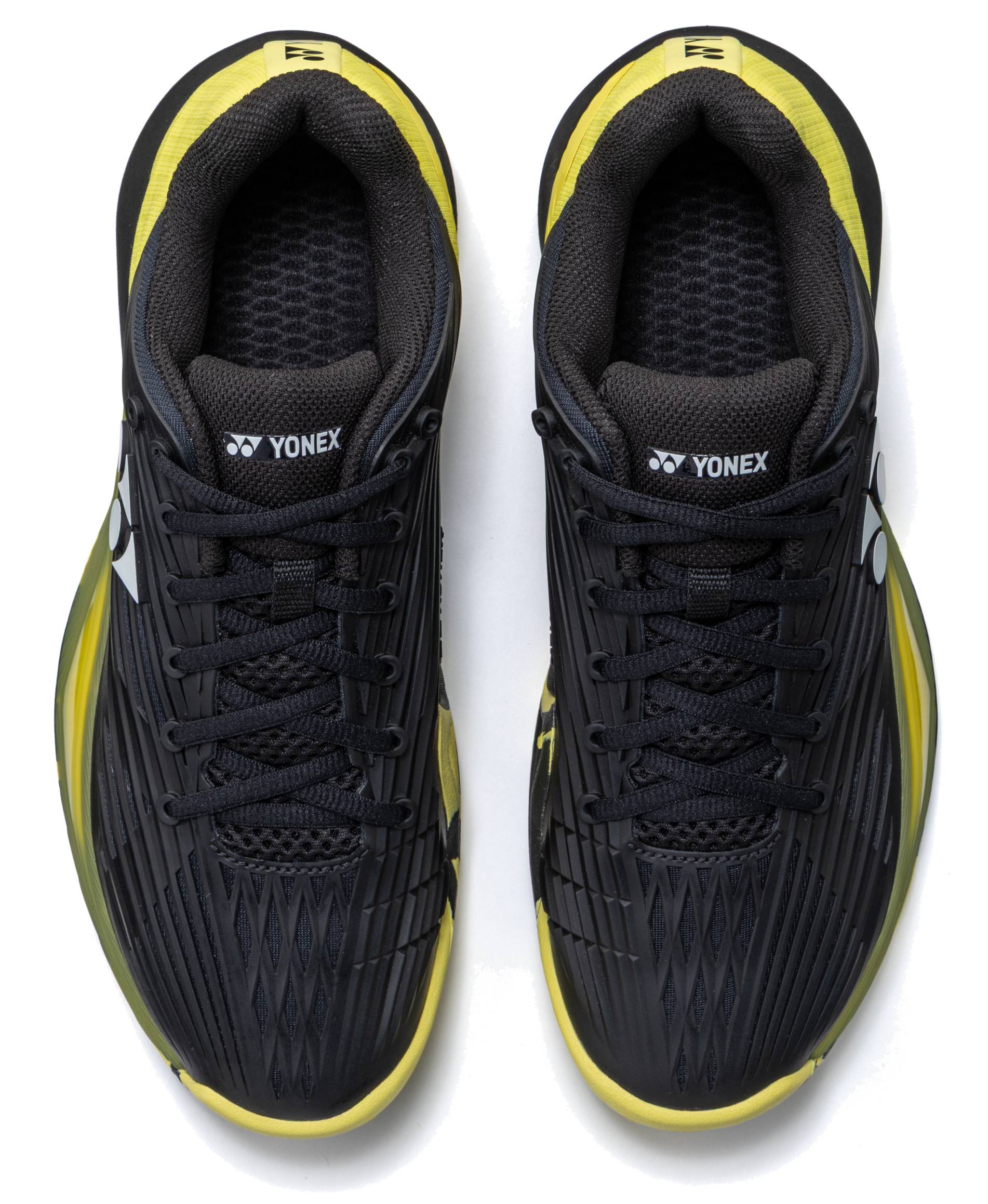 A pair of Yonex Power Cushion Eclipsion 5 Men’s Tennis Shoes in black and yellow, viewed from above. These shoes feature black laces, yellow accents, the Yonex logo on the tongues and sides, and incorporate Yonex’s Power Cushion technology for superior stability on the court.