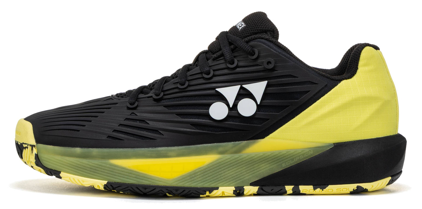 Displayed on a white background, the Yonex Power Cushion Eclipsion 5 Men’s Tennis Shoes in Black/Yellow feature a striking black and yellow design, a distinctive white Yonex logo on the side, black laces, and a textured sole—ideal for anyone seeking men’s tennis shoes known for superior stability, comfort, and performance on the court.