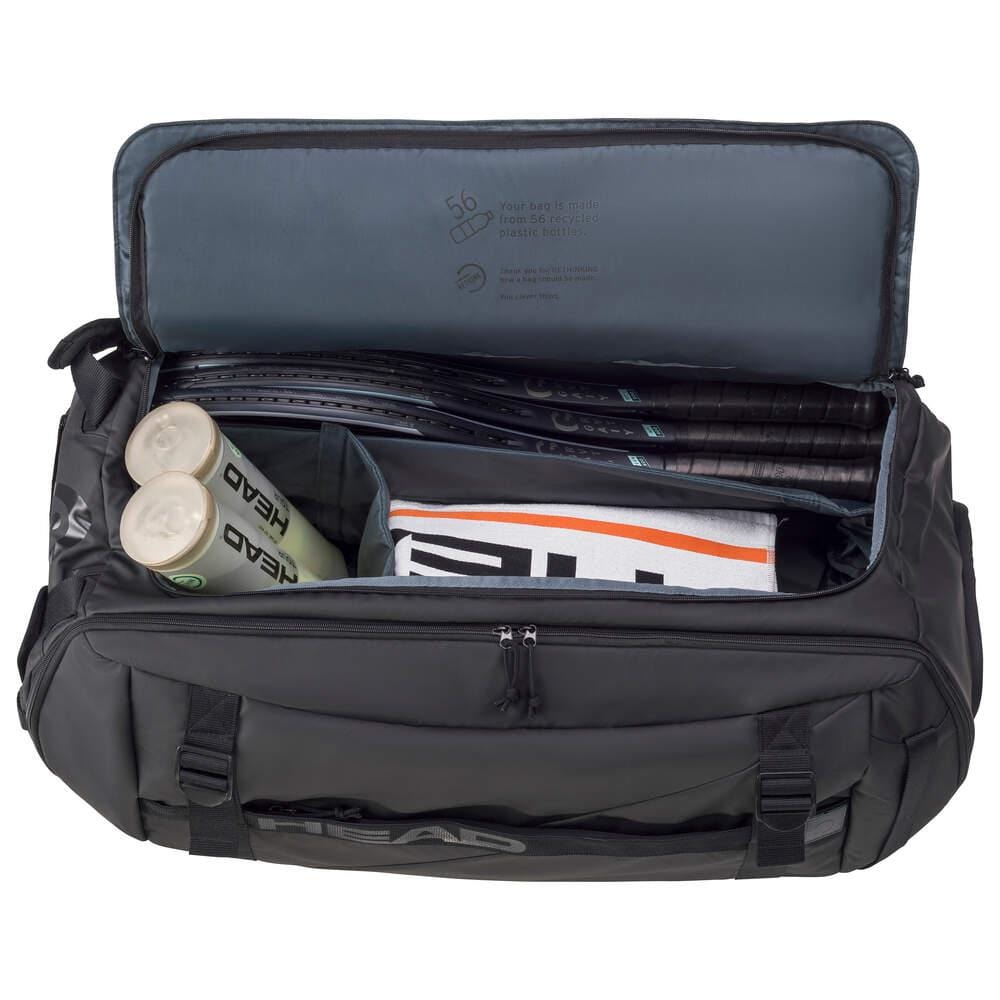 A HEAD Pro X Tennis Duffle Bag XL in black, filled with several rackets, three tubes of tennis balls, and a folded towel. This HEAD bag displays a logo and includes multiple compartments for gear organization, making it an excellent choice for any eco-conscious athlete.