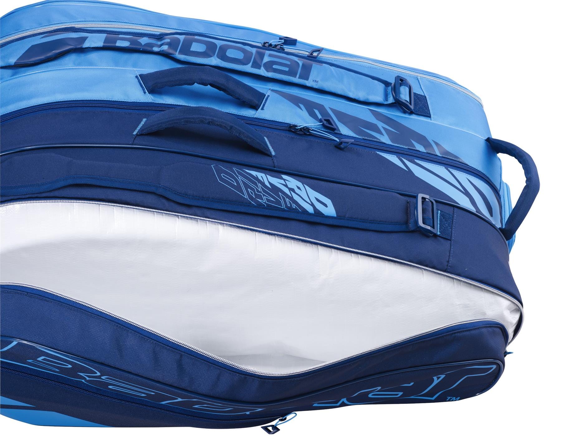 A close-up of the Babolat RH12 Pure Drive 12 Racket Tennis Bag in blue highlights its numerous zippers and compartments. One of the pockets is slightly open, displaying a white, insulated interior ideal for keeping equipment at optimal temperatures.