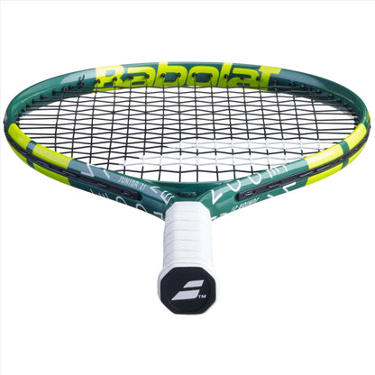 A close-up view of a Babolat Wimbledon 21 Junior Tennis Racket in green, featuring black strings and a white handle. The brand name is prominently displayed on the frame, underscoring its premium design.