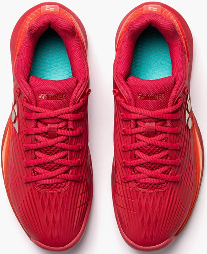 A pair of Yonex Power Cushion Eclipsion 5 Men's Tennis Shoes in Ruby Red, viewed from above. They feature teal insoles, red laces, white Yonex logos on the tongues and sides, and advanced Power Cushion cushioning for tennis performance.