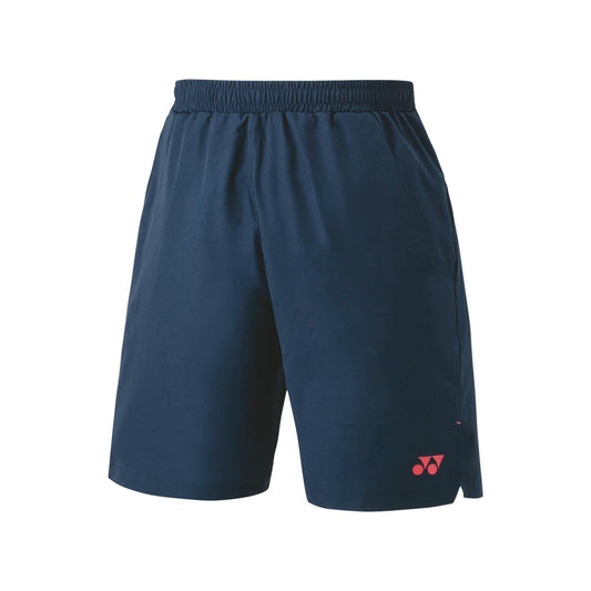 Introducing the Yonex 15165 Men's Tennis Shorts in Indigo Marine, a stylish addition to your tennis wardrobe. These shorts feature an elastic waistband and a subtle pink logo on the lower left leg. With VeryCool technology for ultraviolet reduction, they offer a casual fit and include two convenient side pockets.