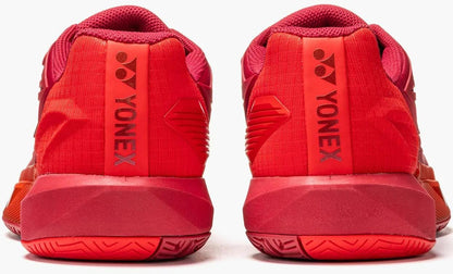 The Yonex Power Cushion Eclipsion 5 Mens Tennis Shoes in Ruby Red are shown from the back, with the Yonex logo and brand name on each heel, featuring advanced tennis shoe technology for athletes.