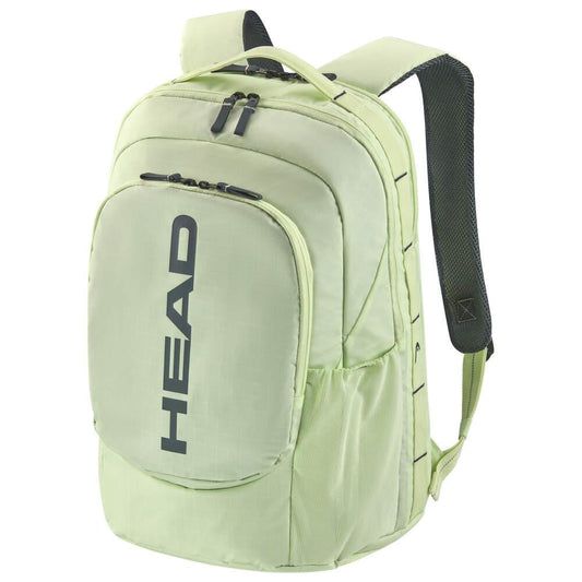The HEAD Pro 30L Tennis Backpack - LLAN in light green is made from durable ripstop fabric and features black straps and zippers. The "HEAD" logo is prominently displayed on the front pocket, providing multiple compartments and a side pocket to keep your gear organized, making it a sustainable choice for a tennis bag.