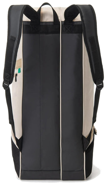 The Yonex BA72626EX Gearlogic 6 Racket Tennis Bag in beige features black padded straps, a rectangular shape, and is made from recycled polyester. The bag stands upright with its back and straps visible.