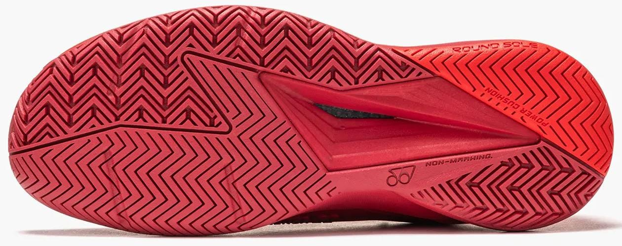 Close-up of the Yonex Power Cushion Eclipsion 5 Mens Tennis Shoes - Ruby Red sole, showing its red herringbone tread, "NON-MARKING" label, and "ROUND SOLE" technology by Yonex for smooth movement on the court.