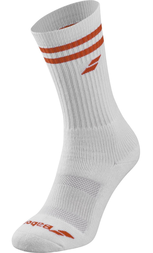 The Babolat Team Single Tennis Sock in White/Cherry Tomato features two red stripes near the top, a small red logo below, ribbed texture, and additional red branding near the toe for both style and comfort.