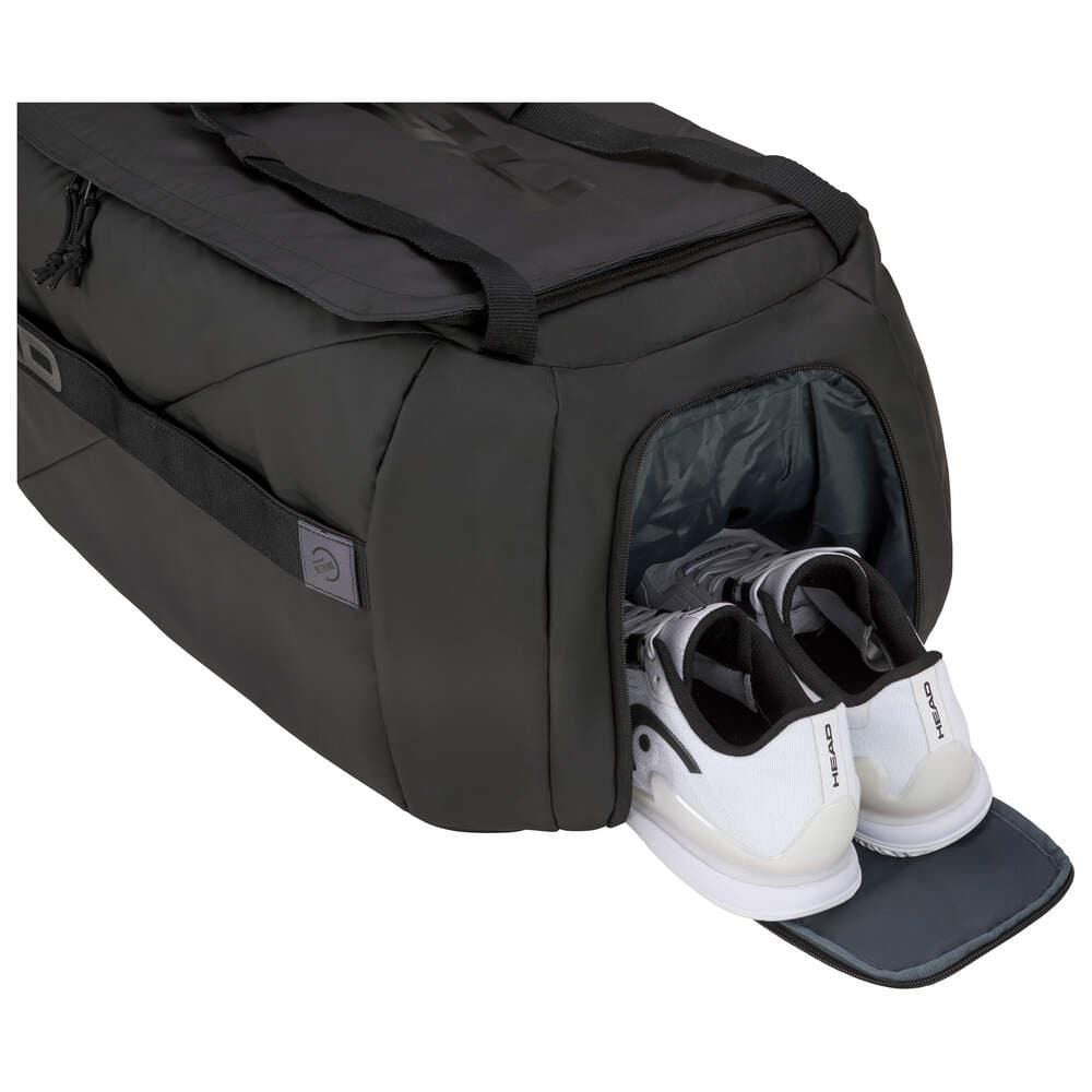 The HEAD Pro X Tennis Duffle Bag L - Black by HEAD is crafted from recycled PET bottles and showcases a side compartment that opens to reveal a pair of white athletic shoes, set against a pristine white background.