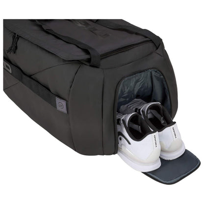 The HEAD Pro X Tennis Duffle Bag L - Black by HEAD is crafted from recycled PET bottles and showcases a side compartment that opens to reveal a pair of white athletic shoes, set against a pristine white background.