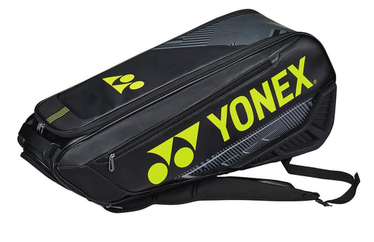 The Yonex 02326EX 2024 Expert 6 Racket Tennis Bag in black and neon yellow showcases a striking design with multiple compartments and prominent zippers for organized storage, while its shoulder straps provide convenient transport for all your sports gear.