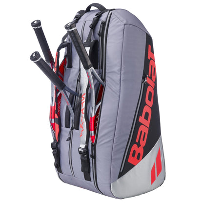 The Babolat RH9 Pure Strike 9 Racket Tennis Racket Bag in carbon grey holds up to nine rackets, features stylish red accents, and offers water-repellent protection for your gear.