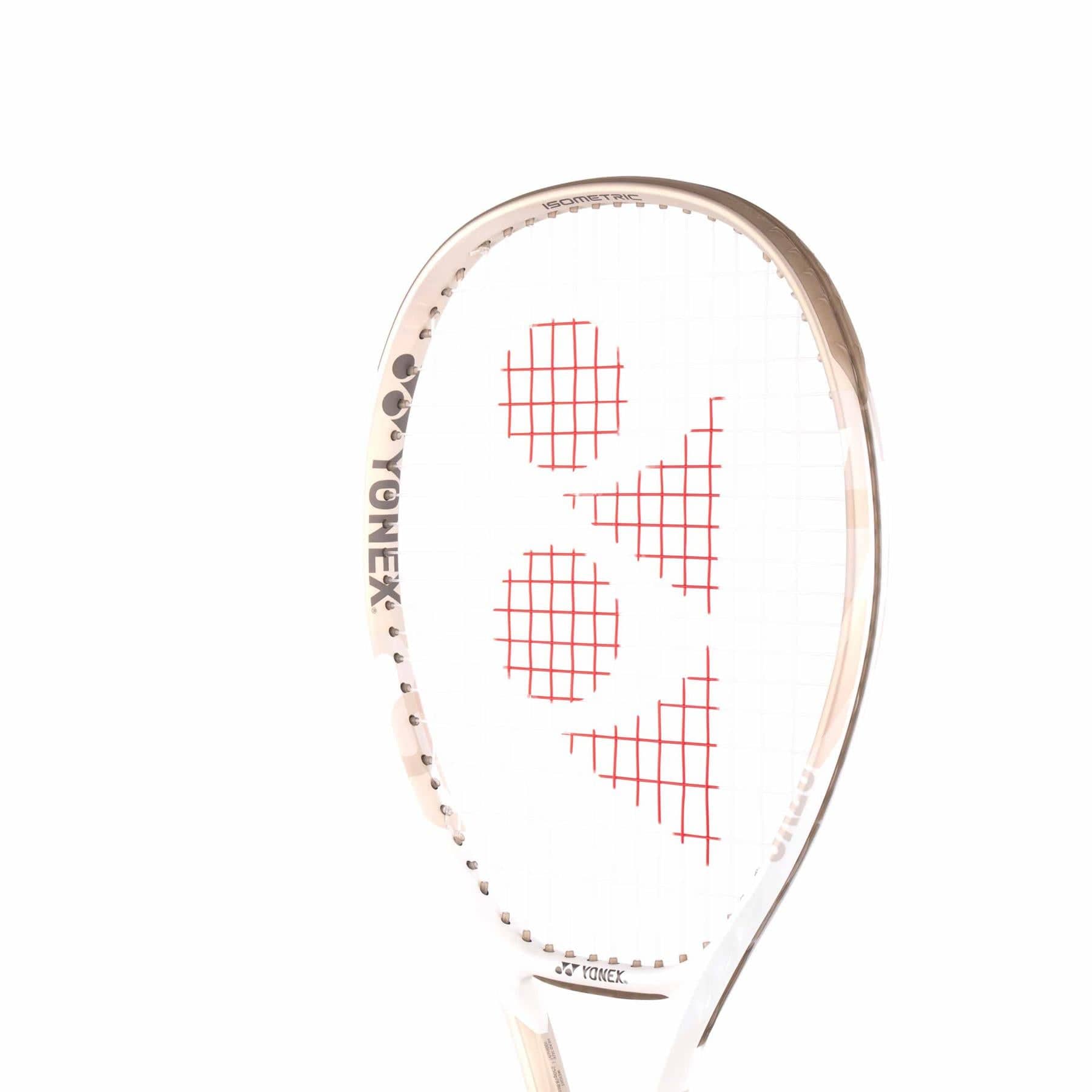 A close-up of the Yonex VCORE Feel Tennis Racket in Sand Beige emphasizes its unique string pattern with red graphics. The frame shines in white and gold, featuring the logo on the side. With ISOMETRIC technology, it ensures precision against a plain white background.