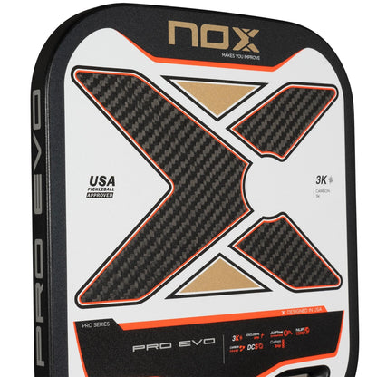 Close-up of the NOX Pro Evo Pickleball Paddle by NOX in black and red, featuring a bold "X" 3K Carbon Fibre design, USA Pickleball Approved label, Exclusive Spin Technology, and stylish product details.