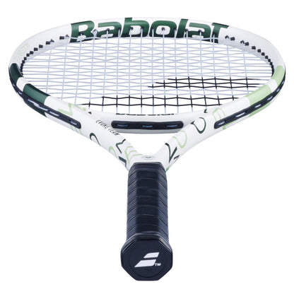 A close-up of the Babolat Evoke Team Wimbledon 2025 Tennis Racket shows its white and champagne green frame, black strings, and black grip handle featuring the Babolat logo at the end.